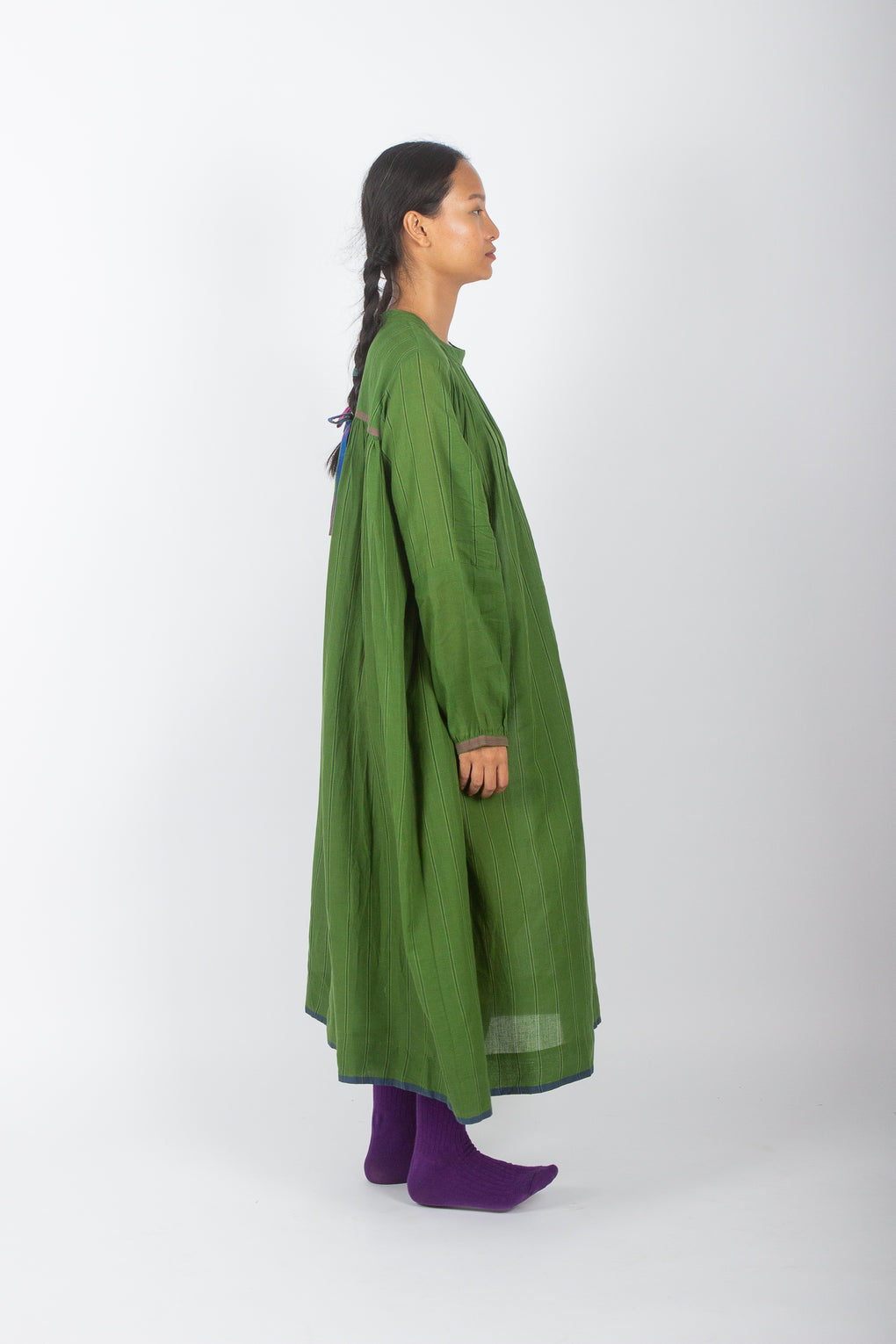 model wearing green maslin loose fir dress by karnam